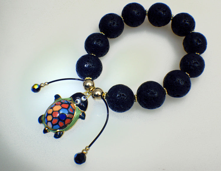 Lava stone bracelet with turtle charm of porcelain 